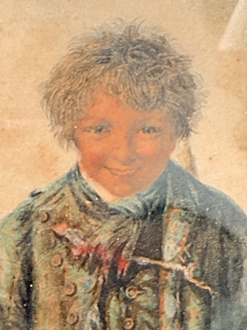 Vintage print of Little Beggar Boy in muted colours, framed under glass in simple wooden frame, on white surface.