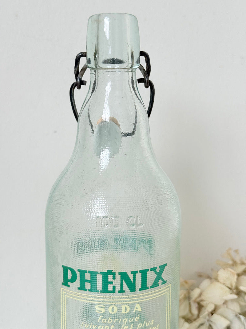 vintage french soda bottle phenix aqua green glass with ceramic swing top 31cm on white surface