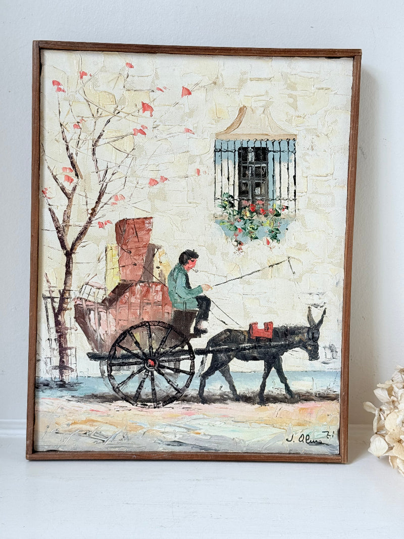 Vintage framed oil painting of horse and cart scene signed L. Cabanes photographed on a white surface