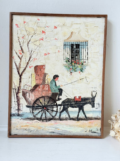 Vintage framed oil painting of horse and cart scene signed L. Cabanes photographed on a white surface