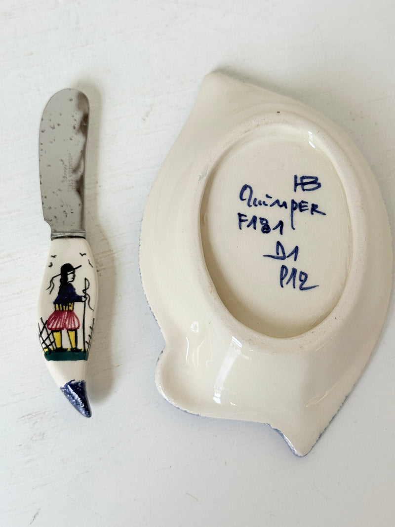 Vintage Quimper butter dish with ceramic knife, hand painted Breton figure, photographed on a white surface