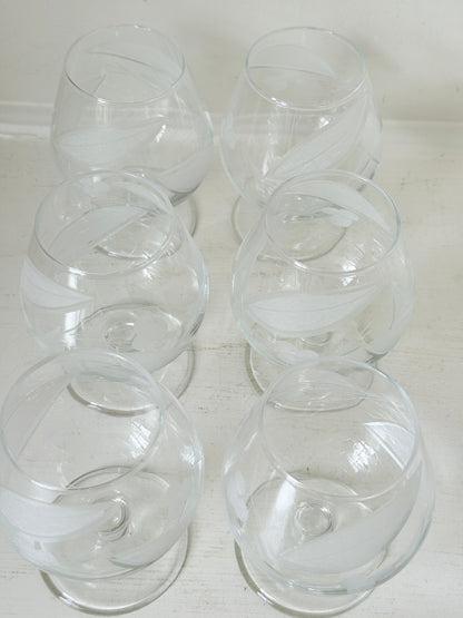 Set of six vintage etched Bailey’s glasses with rounded bowls and short stems, photographed on white surface.