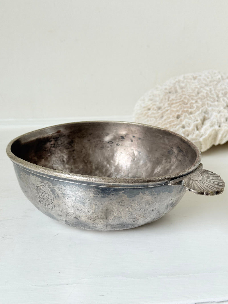 Antique Christofle silver plate bowl with decorative handle, photographed on a white surface.