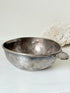 Antique Christofle silver plate bowl with decorative handle, photographed on a white surface.