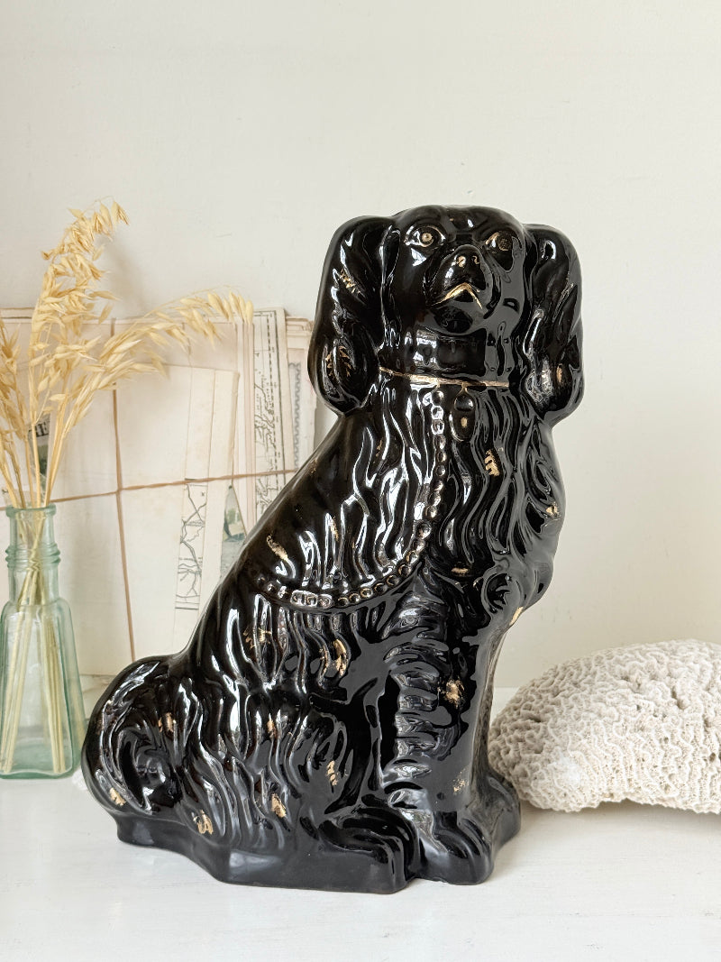 Vintage Staffordshire style black ceramic spaniel dog with gold lustre collar, glossy glaze and textured coat detail