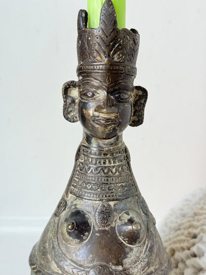 Antique Bengali anthropomorphic brass ritual vessel with goddess figure and lobed headdress, on a white surface
