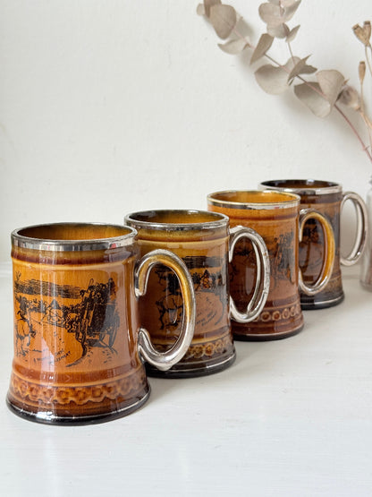 Set of 4 Ridgways stoneware tankard mugs photographed on a white surface in amber brown glaze with black Coaching Days and Coaching Ways transfer scenes