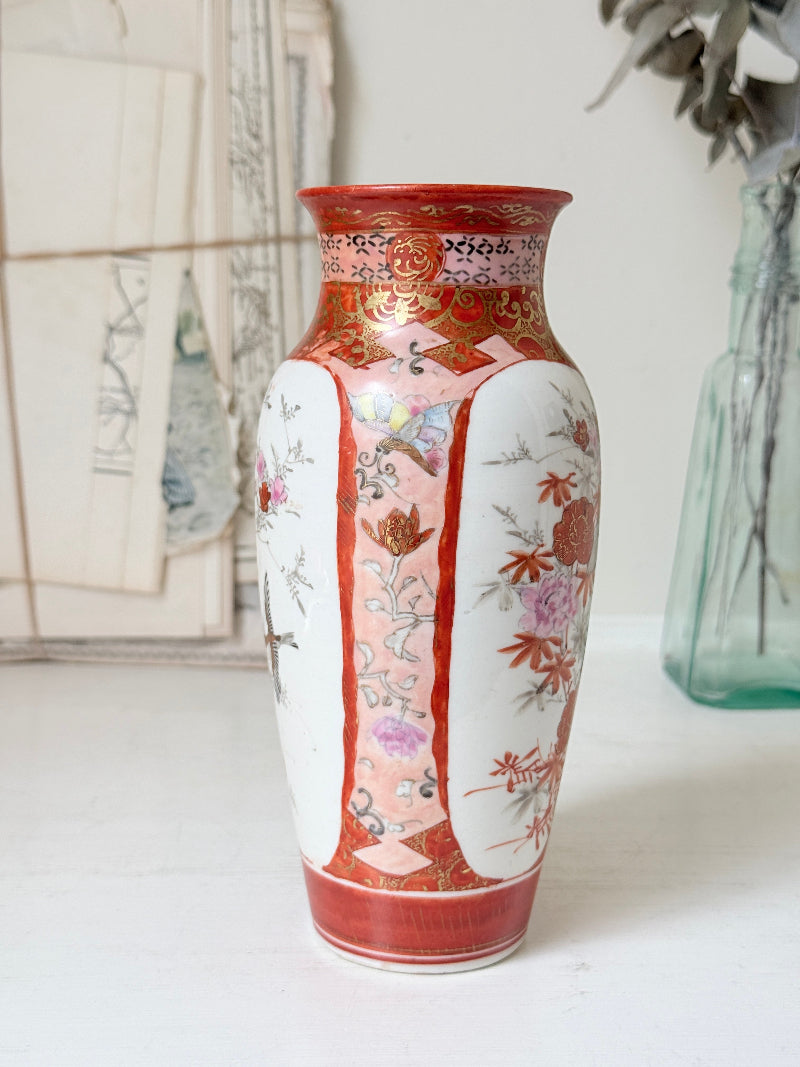 Japanese Kutani porcelain vase hand painted with flowers in white panels on an iron red and gold ground