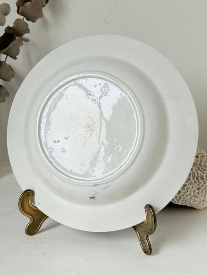 Antique Blue Willow serving bowl with cobalt transfer pattern shown on a white surface.