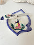 Vintage Quimper butter dish with ceramic knife, hand painted Breton figure, photographed on a white surface