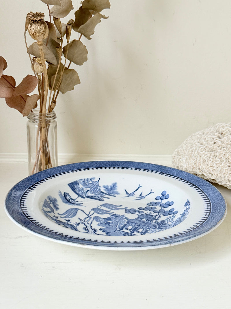 Minton Blue Willow serving dish dated 1928 with blue transfer pattern shown on a white surface.