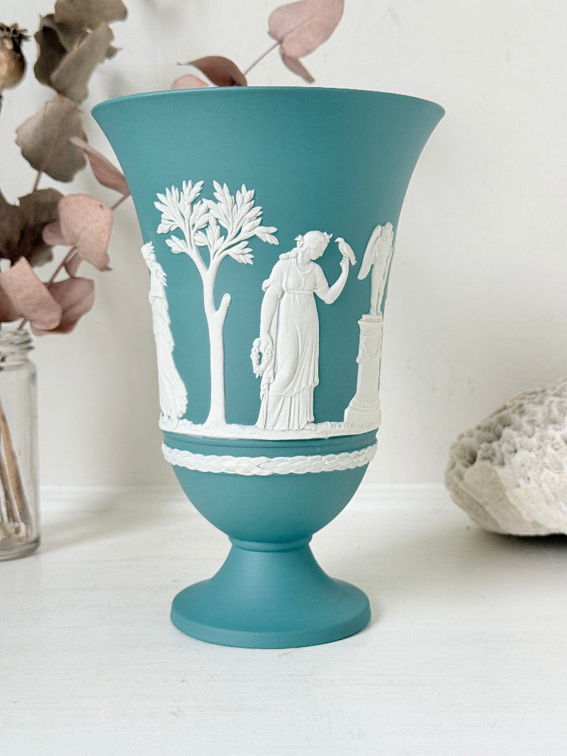 Large vintage Wedgwood Jasperware teal green pedestal vase decorated with white classical Muses figures and stylised trees, styled with dried stems.