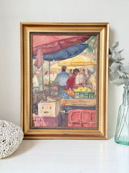 Impressionist oil on board of a busy fruit market with figures and awnings in a gilt frame