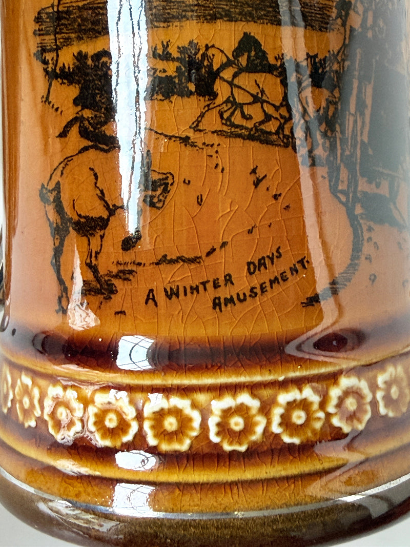 Pair of Ridgways stoneware tankard mugs photographed on a white surface in amber brown glaze with black Coaching Days and Coaching Ways transfer scenes
