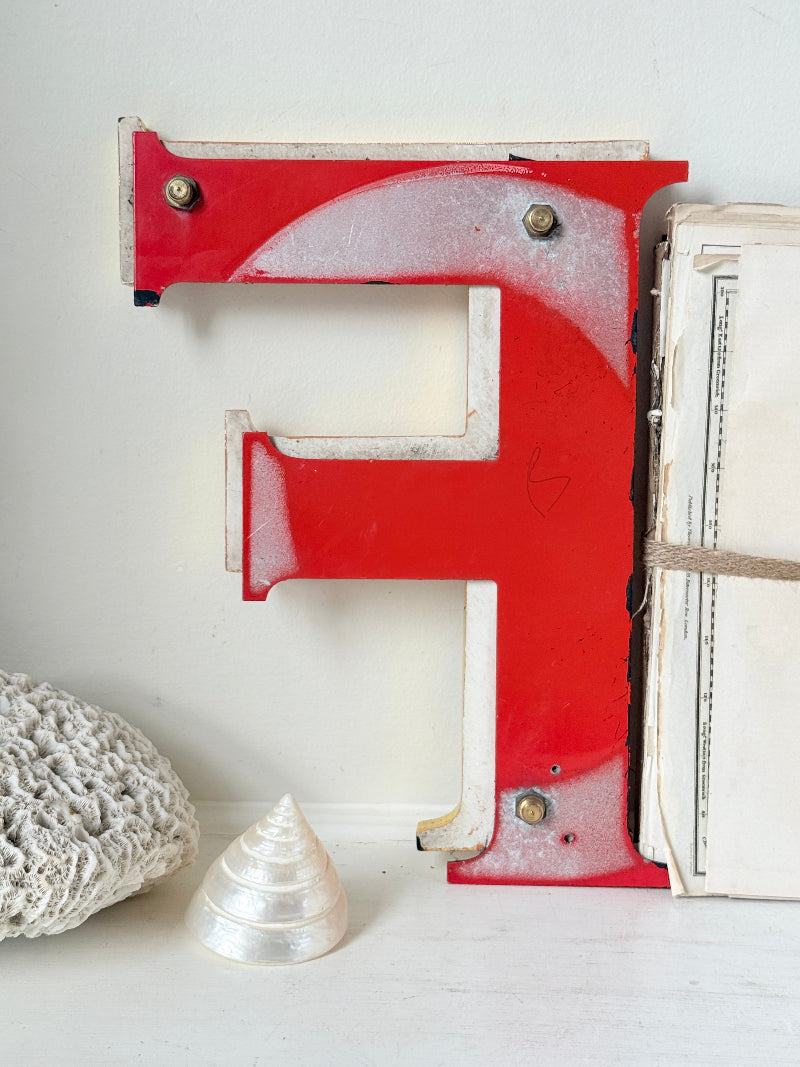 A rustic decorative metal letter &