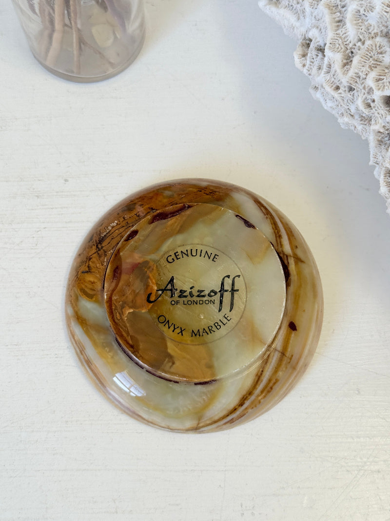 Vintage onyx marble soap dish in honey and cream with banded veining, photographed on a white surface