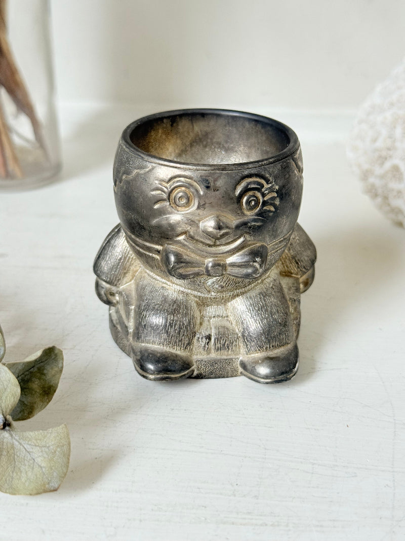 Vintage Humpty Dumpty silver plate egg cup, photographed on a white surface