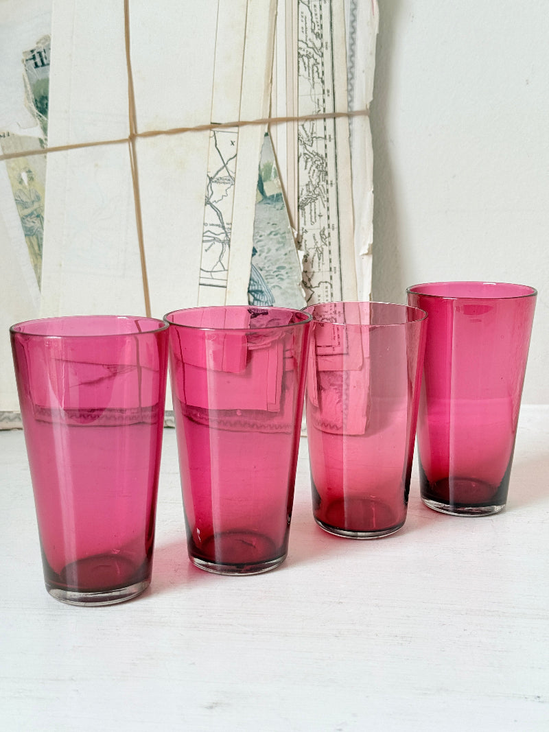 Set of 4 vintage cranberry glass tumblers in tall beaker form with deep pink colour and one slightly paler glass