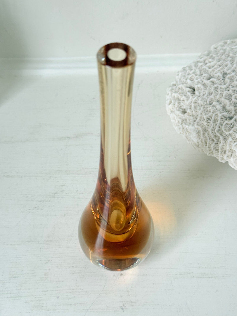 Amber and clear 1960s glass vase with narrow neck and rounded base, photographed on a white surface with dried stems.