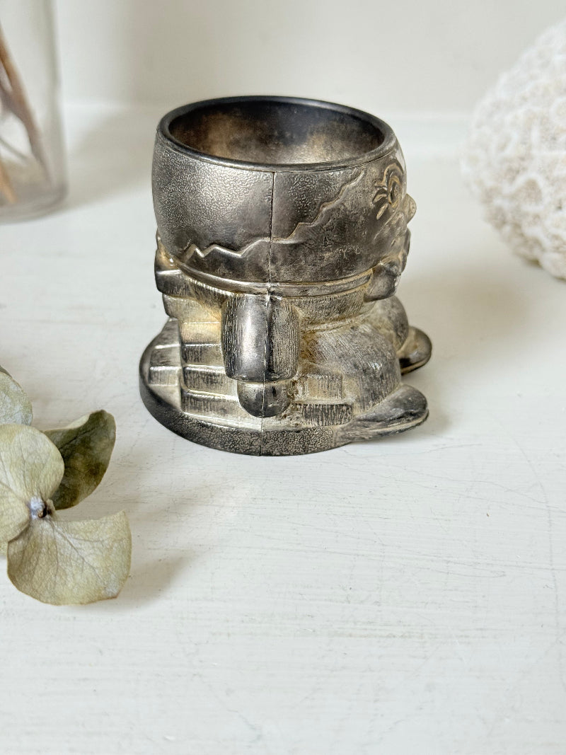 Vintage Humpty Dumpty silver plate egg cup, photographed on a white surface