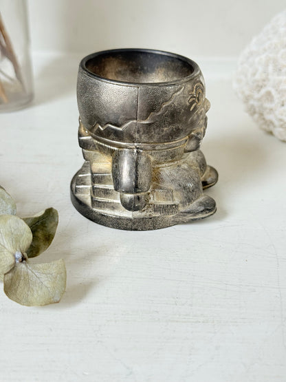 Vintage Humpty Dumpty silver plate egg cup, photographed on a white surface