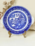 Blue Willow serving plate with scroll handled relief shown on a white surface.