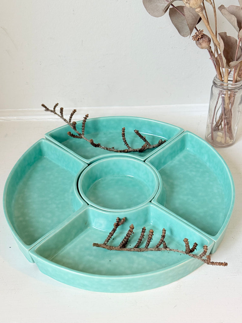 Poole Pottery turquoise hors d’oeuvre dishes set of five displayed on a white surface.
