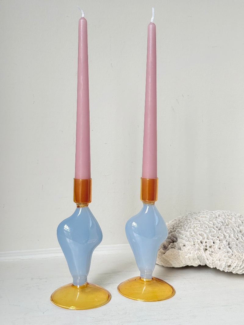 Pair of &amp;Klevering Amsterdam Flux glass candle holders in light blue and amber with pink taper candles