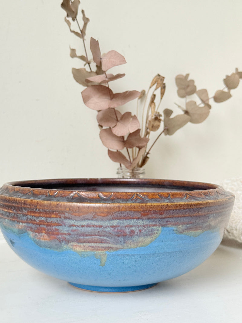 Vintage Bourne Denby stoneware fruit bowl in blue and brown glaze, photographed on a white surface