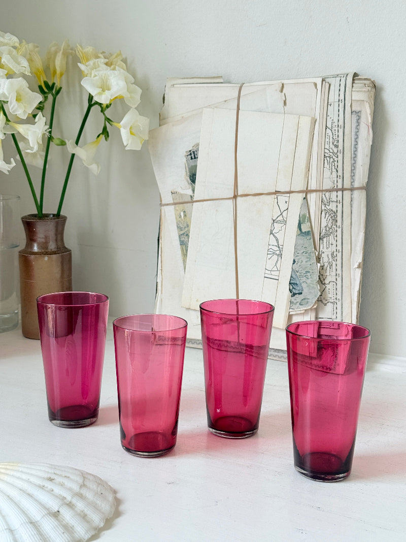 Set of 4 vintage cranberry glass tumblers in tall beaker form with deep pink colour and one slightly paler glass