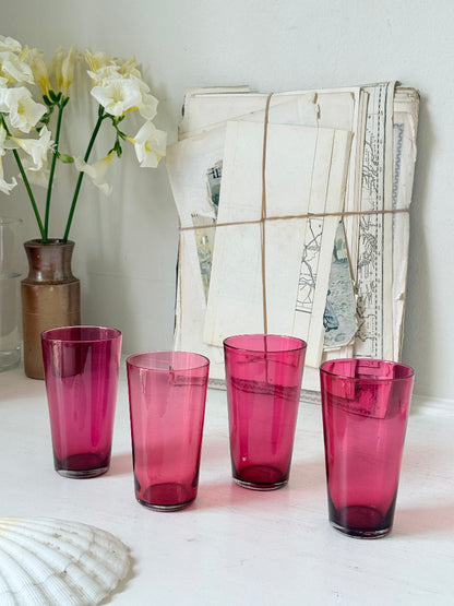 Set of 4 vintage cranberry glass tumblers in tall beaker form with deep pink colour and one slightly paler glass