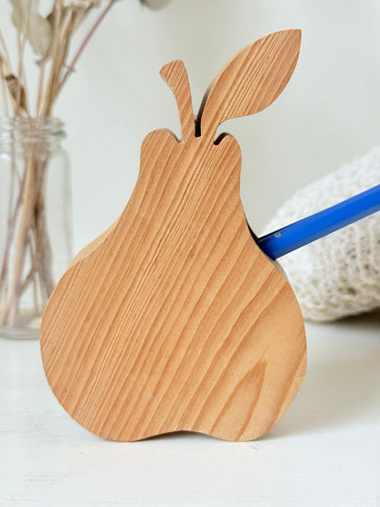 Vintage wooden pear sculpture in natural grain photographed on a white surface.