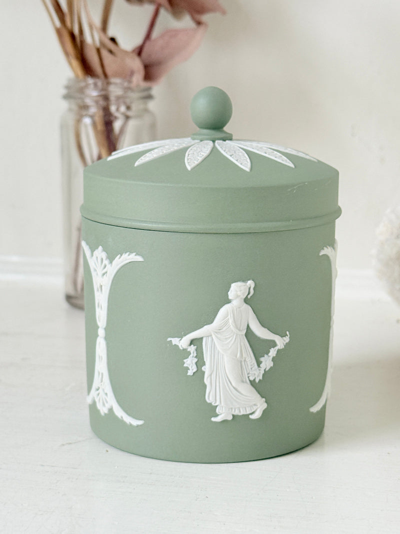 Vintage Wedgwood Jasperware sage green lidded jar with ball finial, decorated with white Dancing Hours neoclassical figures, styled with dried stems.