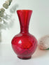 Italian red glass vase with strawberry textured surface, photographed on a white background.