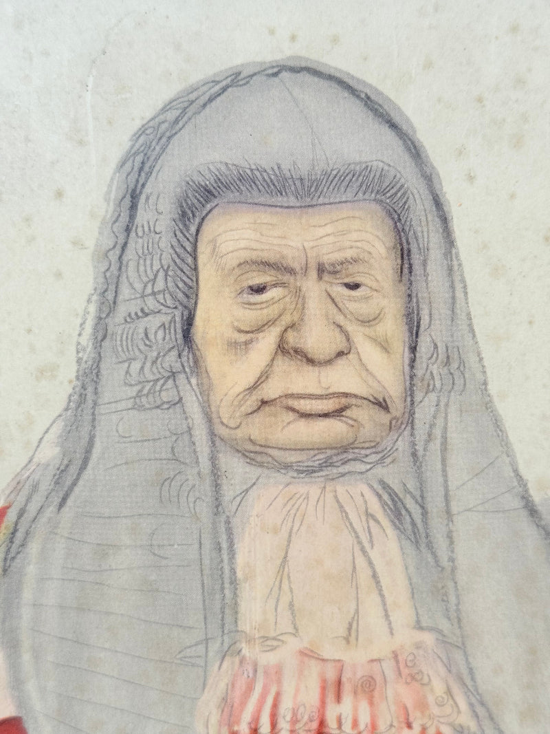 Vintage framed print of judge in ceremonial robes with humorous grumpy expression, photographed on a white surface

