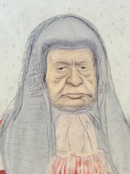 Vintage framed print of judge in ceremonial robes with humorous grumpy expression, photographed on a white surface


