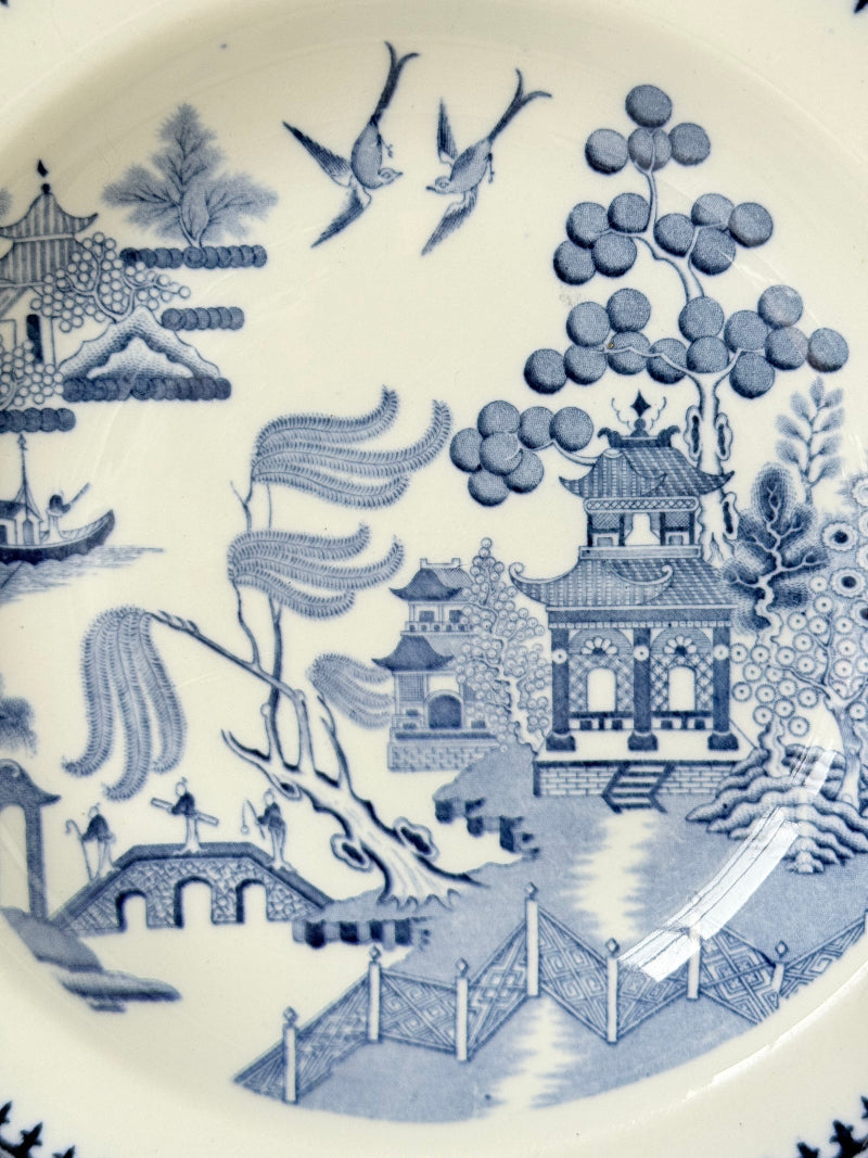 Minton Blue Willow serving dish dated 1928 with blue transfer pattern shown on a white surface.