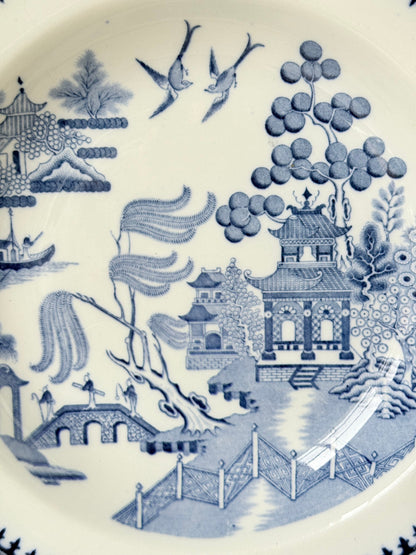 Minton Blue Willow serving dish dated 1928 with blue transfer pattern shown on a white surface.