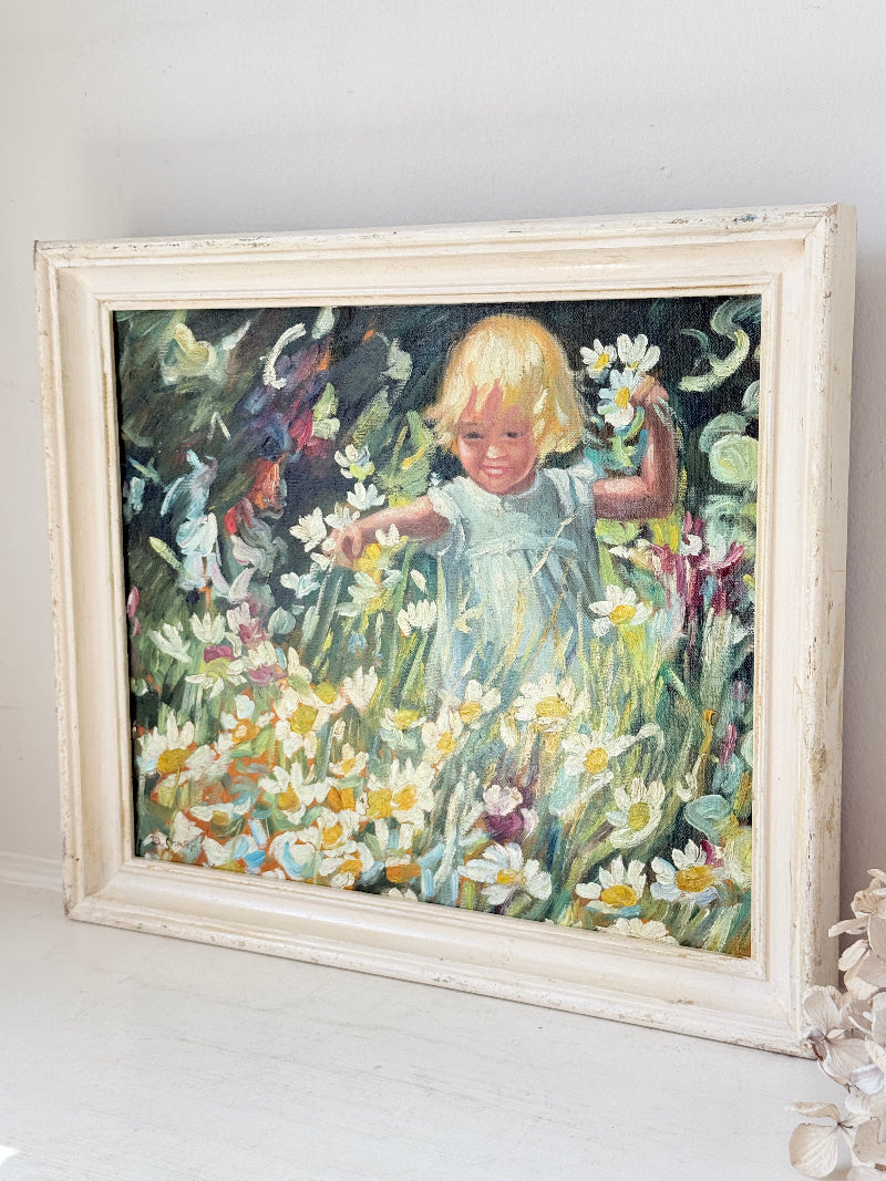Oil painting after Dorothea Sharp of a young girl picking white flowers in a meadow, distressed white wood frame