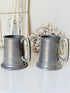 Pair of hammered English pewter tankards by E H Parkin of Sheffield, photographed on a white surface