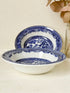 Pair of vintage blue and white Blue Willow snack bowls with patterned border photographed on a white surface
