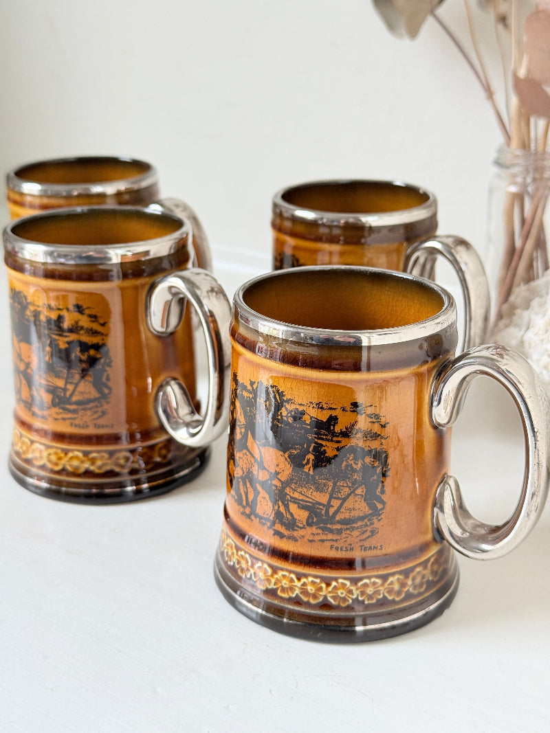 Set of 4 Ridgways stoneware tankard mugs photographed on a white surface in amber brown treacle glaze with black Coaching Days and Coaching Ways transfer scenes