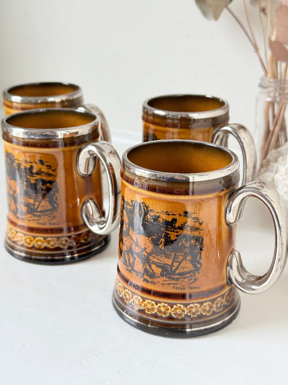 Set of 4 Ridgways stoneware tankard mugs photographed on a white surface in amber brown treacle glaze with black Coaching Days and Coaching Ways transfer scenes