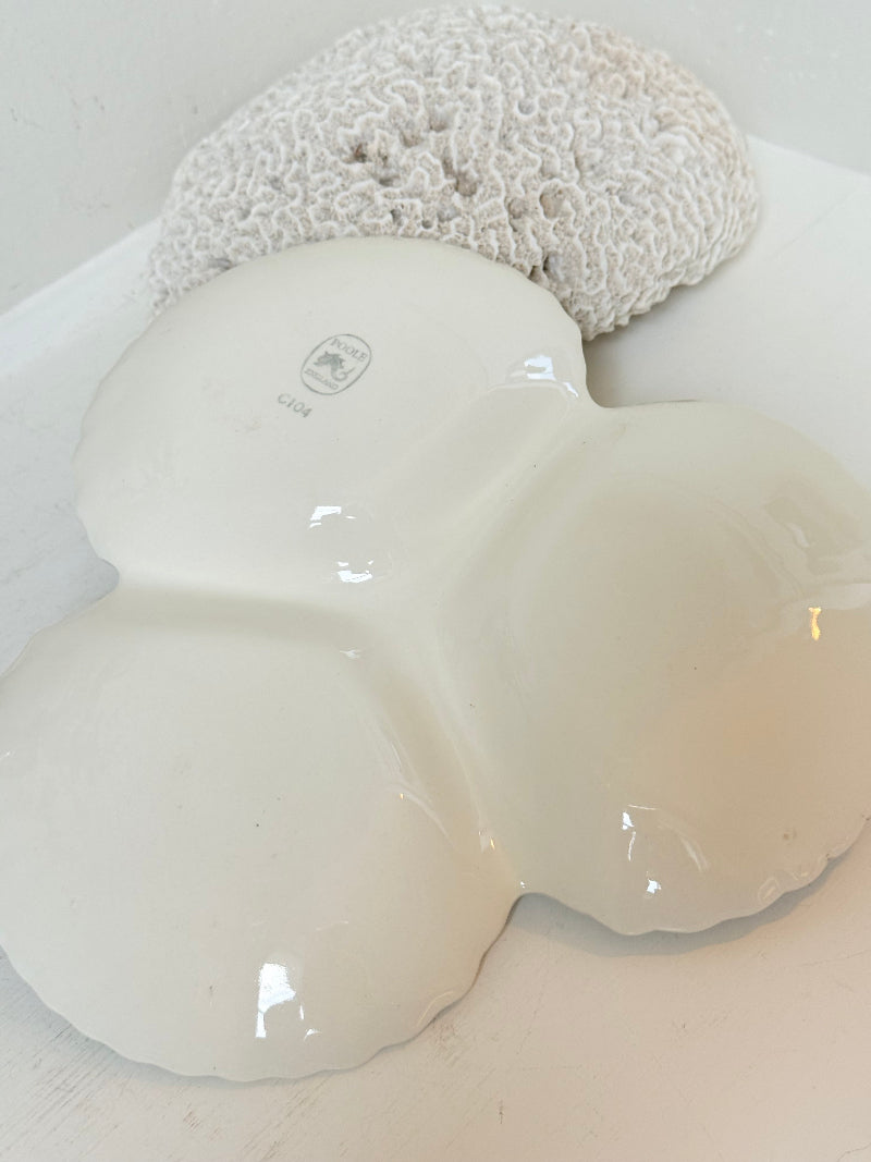 Poole Pottery triple scallop hors d’oeuvre dish in grey glaze with powder blue handle photographed on a white surface