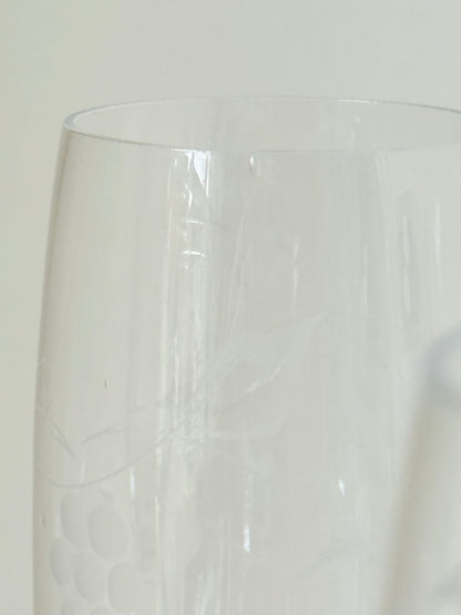 Set of six vintage French champagne flutes with tall clear bowls and cobalt blue twisted stems, photographed on white surface.