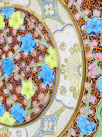 Antique Japanese Aoki Brothers platter with colourful Imari style floral pattern photographed on a white surface