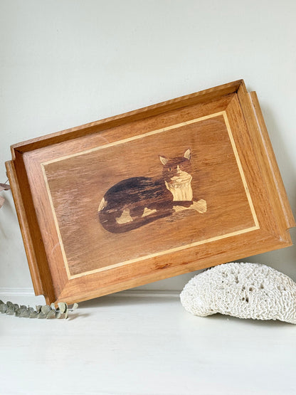 Vintage wooden tray with cat marquetry inlay, photographed on a white surface