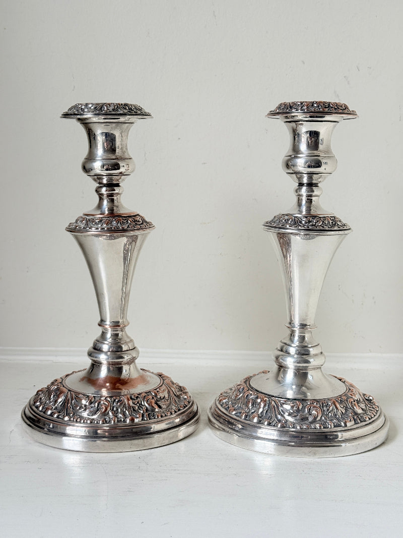 Pair of convertible silver plate on copper candelabra with repoussé detail, removable arms and green taper candles