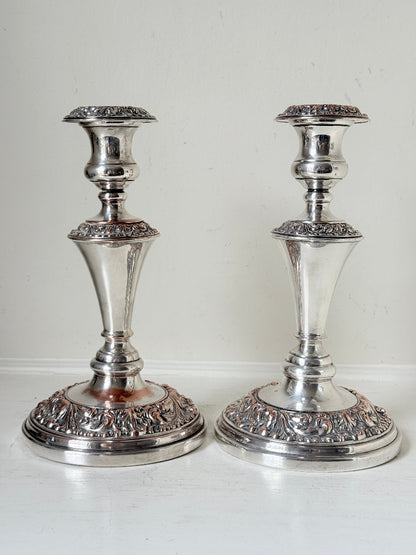 Pair of convertible silver plate on copper candelabra with repoussé detail, removable arms and green taper candles
