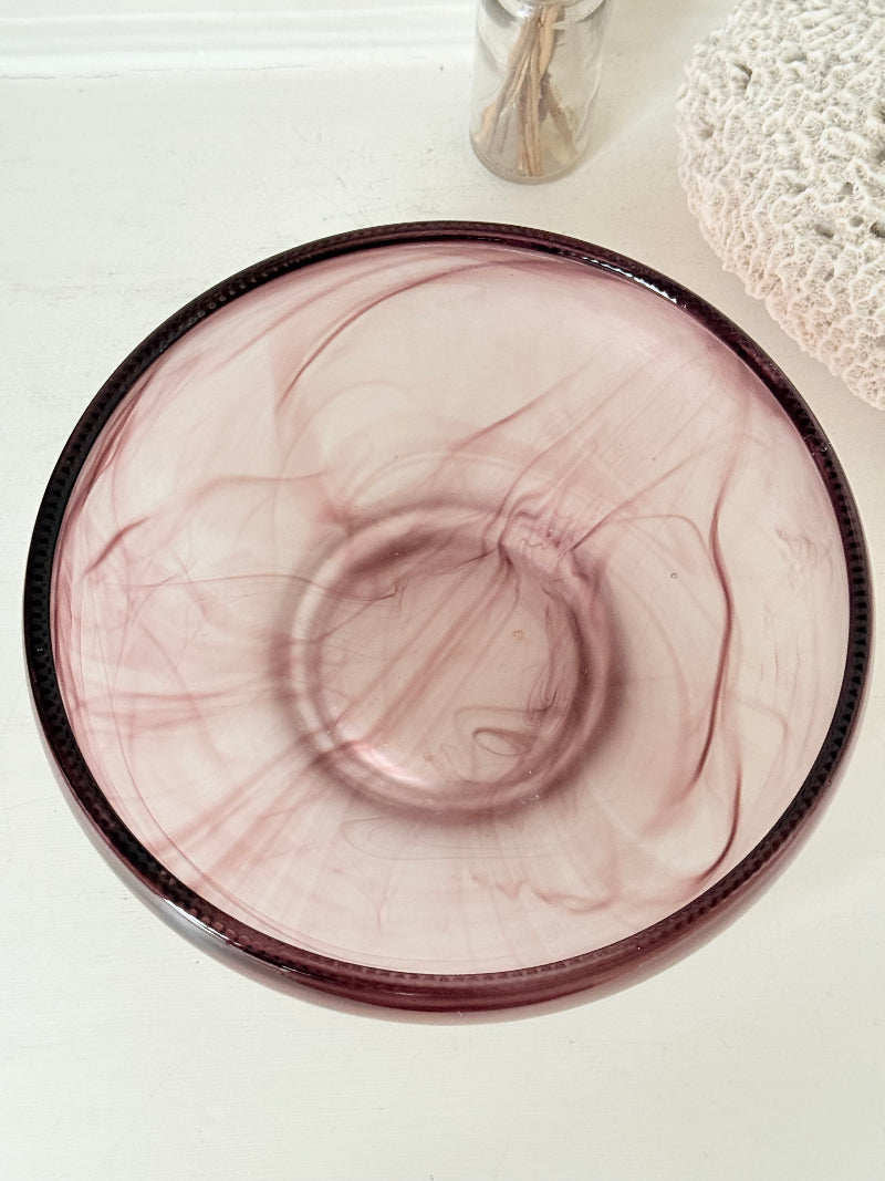 Vintage Davidson cloud glass bowl in mauve pink swirl photographed on a white surface